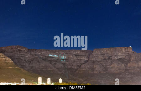 Cape Town, Afrique du Sud, le jeudi 12 décembre 2013 : un laser contours image de Nelson Mandela est projetée sur la Montagne de la table pendant la nuit pour lui rendre hommage après sa mort le 5 décembre 2013. Madiba était son nom de clan et le nom par lequel il est souvent abordée. Crédit : Eric Nathan/Alamy Live News Banque D'Images