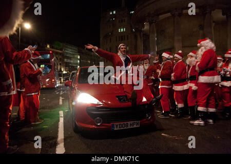 Londres, Royaume-Uni. 14 Décembre 2013 Un participant de l'événement annuel les attelages Santa Con un roulement tout en fête à l'extérieur BBC Broadcasting House à Portland Place. Credit : Nelson Pereira/Alamy Live News Banque D'Images
