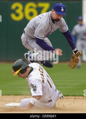 Jul 14, 2001 ; Oakland, CA, USA ; Los Angeles Dodgers' Jeff Reboulet,# 14, bondit sur Oakland A's Frank Menechino, # 11, après avoir jeter Jeremy Giambi, # 7, à la première base pour le double jeu dans la 6e manche de leur jeu Samedi, 14 juillet 2001 à l'Oakland Coliseum à Oakland, Californie Les Dodgers battre les A's 5-3. Banque D'Images