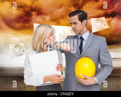 Image composite d'architectes avec plans and hard hat looking at each other Banque D'Images