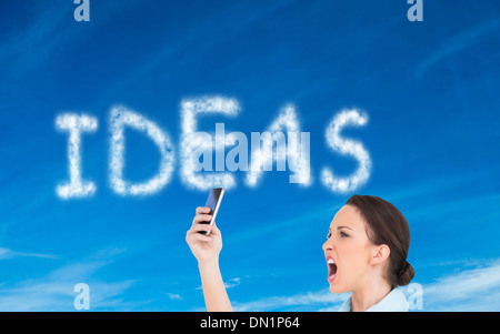 Image composite de angry classy businesswoman yelling at her smartphone Banque D'Images