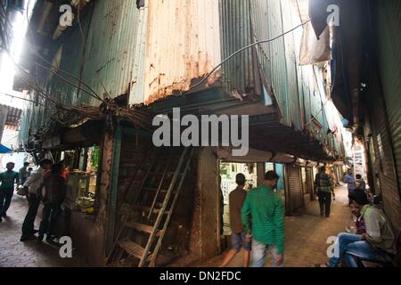 Mumbai, Inde. Dec 18, 2013. Les personnes sont considérées dans une ruelle dans le bidonville de Mumbai, Inde, 18 décembre 2013. De l'autre côté de l'Inde centre économique et financier, Mumbai, il se trouve un des plus grands bidonvilles du pays. Les résidents vivent dans des salles encombrées, minable, et le craps sont vus partout. Mais la vie à Mumbai, la bidonville n'est pas tout au sujet de la pauvreté et de pessimisme, certaines personnes ont commencé à ouvrir des magasins, d'envoyer leurs enfants à l'école et de faire des affaires. Banque D'Images