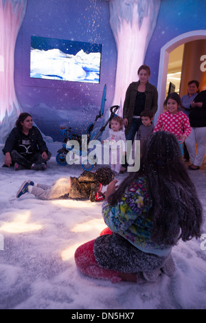 Enfants jouant dans la neige artificielle dans le palais de glace à l'écran Noël Bevery Center de Los Angeles, CA Banque D'Images