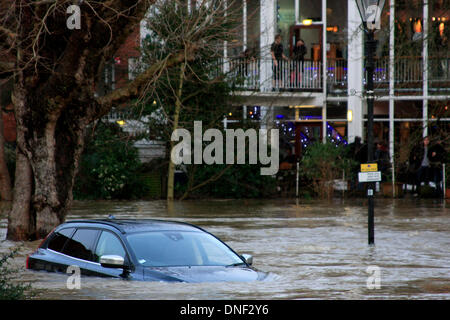 Guildford, Surrey, UK 24 décembre 2013. L'augmentation des eaux d'inondation de la rivière Wey enveloppant une voiture dans le parking de l'Millmead Yvonne Arnaud Theatre dans l'arrière-plan. Les inondations ont été causées par de fortes pluies au cours des dernières 24 heures. Credit : Bruce McGowan/Alamy Live News Banque D'Images