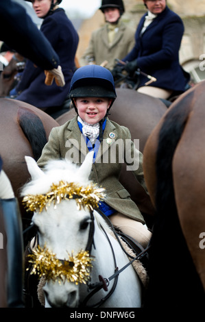 Jeune fille en équipement d'équitation sur poney avec tinsel avant l'Heythrop Hunt Boxing Day rencontrez Banque D'Images