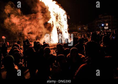 Thessalonique, Grèce. Le 24 décembre, 2013. Les gens se rassemblaient autour du feu pendant la veille de Noël. La veille de Noël de la ville de Florina en Grèce du Nord et les villages environnants une tradition particulière se fait appelé ãƒæ'Ã'àƒ¢â''àƒ ?š š ?l''firesÃƒAE'Ã'Â'''Àƒæ Sàƒæ ?š Â''. Au cours de cet événement les habitants des grands incendies dans chaque partie de la ville. Cette tradition est dit que éloigne les mauvais esprits et symbolise les bergers qui visitent le nouveau-né le Christ. L'éclat de l'incendie devrait réchauffer l'enfant. Autour du feu, les habitants et les touristes de la danse, de boire du vin et manger de la soupe de haricots.Photo : Giannis Papanik Banque D'Images