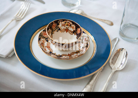 Table de salle à manger formelle avec Blue-Accented Tasse et soucoupe sur la plaque avec de l'Argenterie Banque D'Images