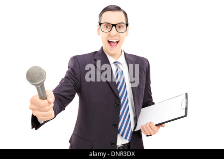 Jeune mâle excité interviewer in suit holding microphone Banque D'Images