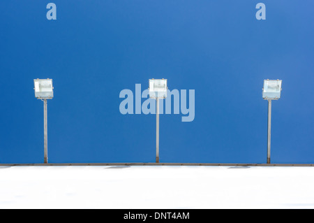 Pleins feux sur fond de ciel bleu sur le mur Banque D'Images