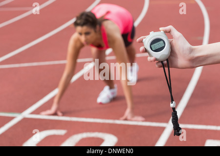 Main d'une femme de distribution exécuter sur la piste de course Banque D'Images