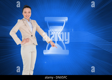 Composite image of asian businesswoman pointing Banque D'Images
