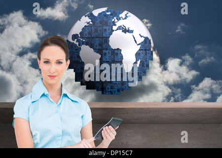 Composite image of businesswoman using calculator Banque D'Images