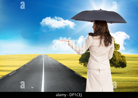 Composite image of businesswoman holding glasses Banque D'Images