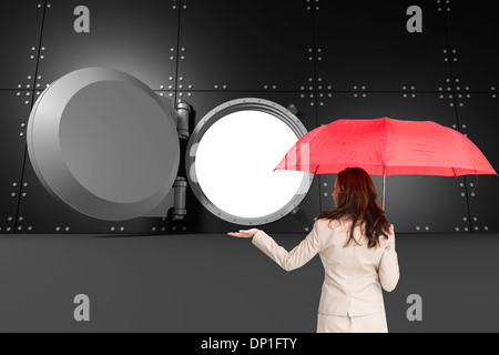 Composite image of businesswoman holding umbrella Banque D'Images