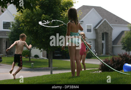 Jun 27, 2006 ; Blaine, MN, USA ; Lauren Lafeber, 8, Centre, donne un bain à ses frères et sœurs Connor, 6, gauche, et Emily, tout en jouant à l'extérieur de leur résidence de Blaine Le mardi 27 juin 2006, près de la Tournament Players Club de golf. Blaine est passé d'une plaine aride à un haut lieu de sport et d'accueil de millions de dollars et une qualité d'hôtels particuliers de la PGA de golf. Les Vikings ont récemment pris e Banque D'Images