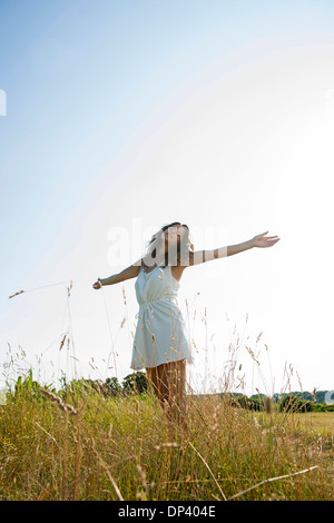 Little Girl standing in field with arms outstretched, Allemagne Banque D'Images