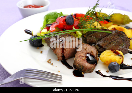 Steak d'agneau avec des pommes de terre, légumes et sauce balsamique, Close up Banque D'Images