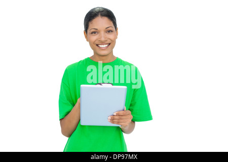 Cheerful model wearing tshirt recyclage holding tablet Banque D'Images