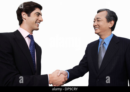 Happy businessmen shaking hands over white background Banque D'Images