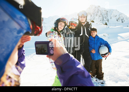 Girl photographing family, Les Arcs, Haute-Savoie, France Banque D'Images