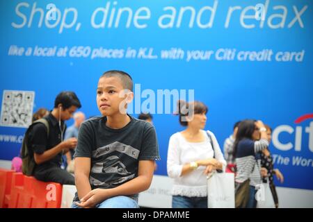 Kuala Lumpur, MYS, . 10 janvier, 2014. Un jeune garçon est assis sur la barricade de la construction par les rues de Kuala Lumpur, Malaisie, le vendredi, Janvier 10, 2014. © Joshua Paul/NurPhoto ZUMAPRESS.com/Alamy/Live News Banque D'Images