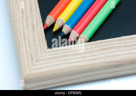 Crayons de couleur sur un tableau noir Banque D'Images