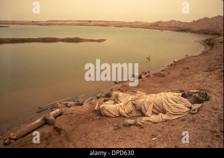 Iran guerre en Irak également connue sous le nom de première Guerre du Golfe persique ou Guerre du Golfe 1984. Un soldat mort dans les marais mésopotamiens. Une tempête de sable dans l'air. Près de Basra, dans le sud de l'Irak. HOMER SYKES des années 1980 Banque D'Images