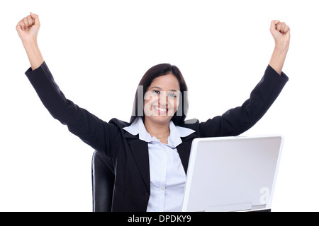 Successful business woman with arms up against white background Banque D'Images