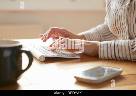 Portrait de femme de la saisie sur clavier sans fil Banque D'Images