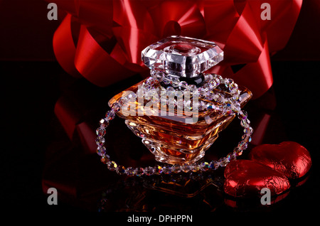 Flacon de parfum sur fond noir avec décor Banque D'Images