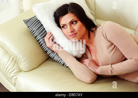 Middle-aged pensive woman lying on the sofa Banque D'Images