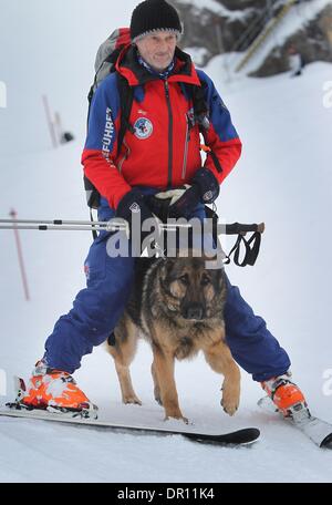 Garmisch-Partenkirchen, Allemagne. 17 Jan, 2014. Avalanch entraîneur de chien Franz Schreiber skies sur la pente avec rescue dog Aico entre ses jambes lors d'un exercice d'entraînement dans les Alpes, près de Garmisch-Partenkirchen, Allemagne, 17 janvier 2014. Dresseurs de chiens de sauvetage en montagne sont la formation de leurs chiens de recherche de victimes d'avalanche pour une semaine. Photo : Karl Josef OPIM/dpa/Alamy Live News Banque D'Images