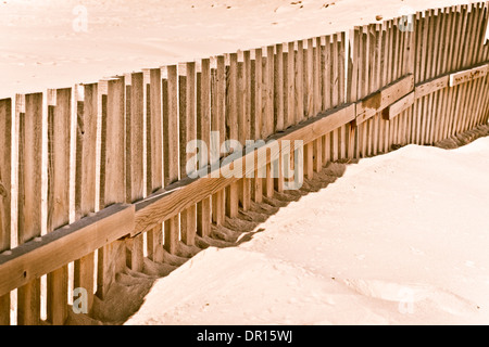 Clôture en bois sur une plage de sable. Banque D'Images