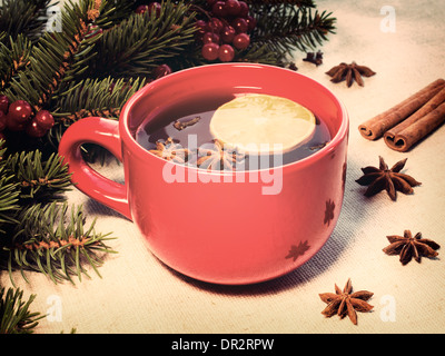 Vin chaud chaud versé dans une tasse en céramique rouge Banque D'Images