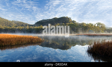 Paysage spectaculaire, la brume sur le lac, la forêt et le ciel reflète dans l'eau bleu Dunn des marais du parc national Wollemi NSW Australie Banque D'Images