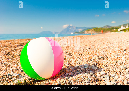 Ballon gonflable coloré sur une plage de galets Banque D'Images