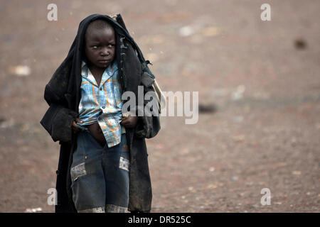 Dec 07, 2008 - Goma, République démocratique du Congo - Un garçon congolais se promène dans l'IDP (personnes déplacées à Kibati personne) camp, 10 km (6 miles) au nord de Goma, sous un lourd manteau. De nombreux Congolais déplacés portez des vêtements pour parer à des frissons. (Crédit Image : © T.J. Kirkpatrick/ZUMA Press) Banque D'Images