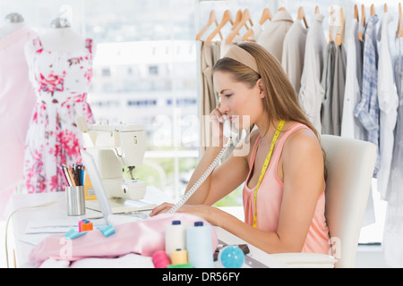 Jeune femme Fashion designer using phone Banque D'Images