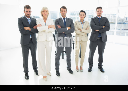 Confident business team with arms crossed in office Banque D'Images