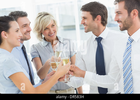 Business team toasting with champagne in office Banque D'Images