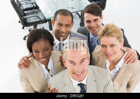 Close business team smiling up at camera Banque D'Images