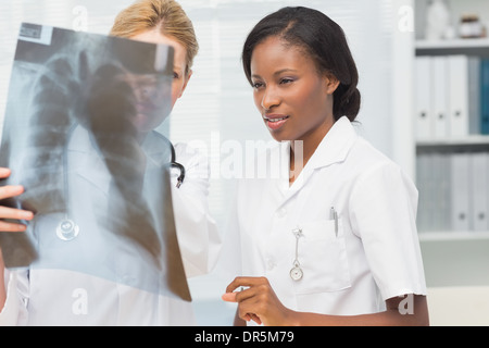 Cheerful doctor and nurse looking at xray together Banque D'Images