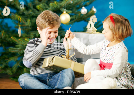 Enfants déballer des cadeaux de Noël, Munich, Bavière, Allemagne Banque D'Images