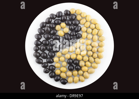 Yin et Yang fait des olives vertes et noires sur la plaque Banque D'Images