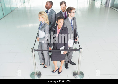 Business people standing in roped-off square Banque D'Images