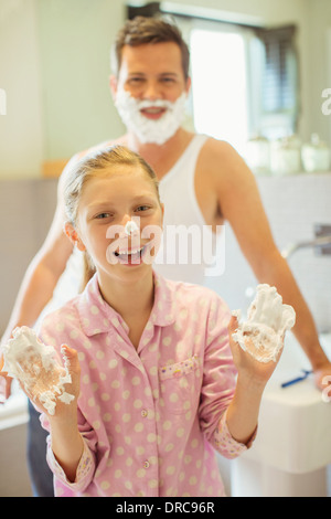 Père et fille jouer avec la crème à raser Banque D'Images