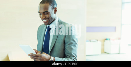 Businessman using digital tablet in office Banque D'Images