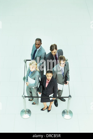 Business people standing in roped-off square Banque D'Images