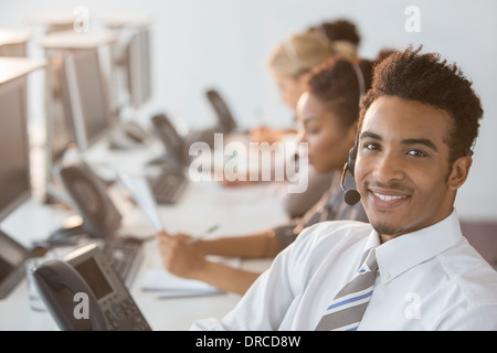 Businessman wearing headset in office Banque D'Images