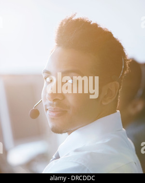 Businessman wearing headset in office Banque D'Images